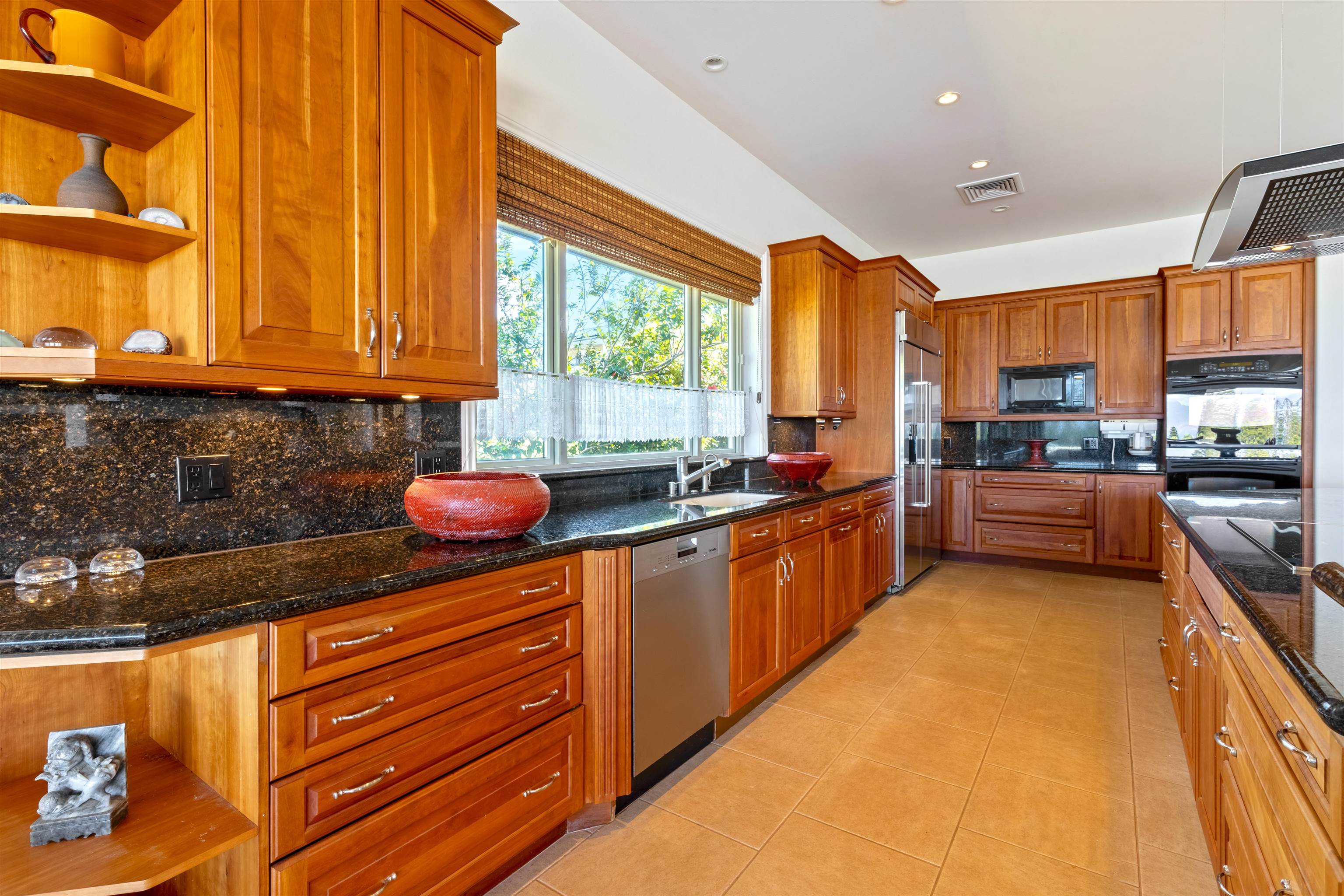 232 Crestview Road Lahaina, HI 96761 - Photo 12 of 45 a kitchen with stainless steel appliances wooden cabinets a stove top oven a sink and dishwasher