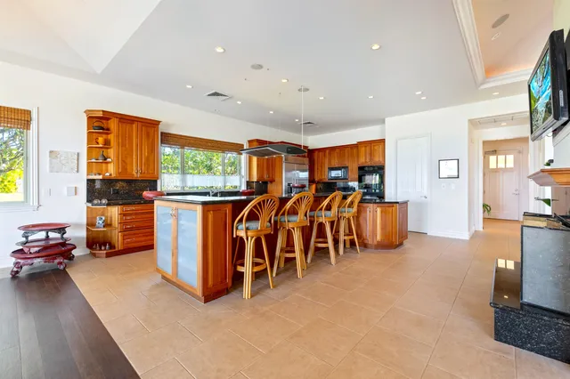 a living room with furniture a flat screen tv and next to a window