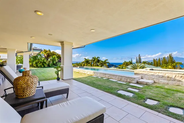 a view of a patio with couches table and chairs with potted plants