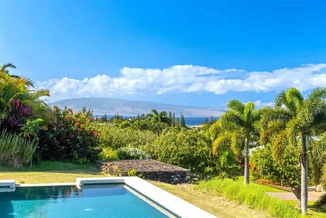 a view of a swimming pool with an outdoor seating and a yard