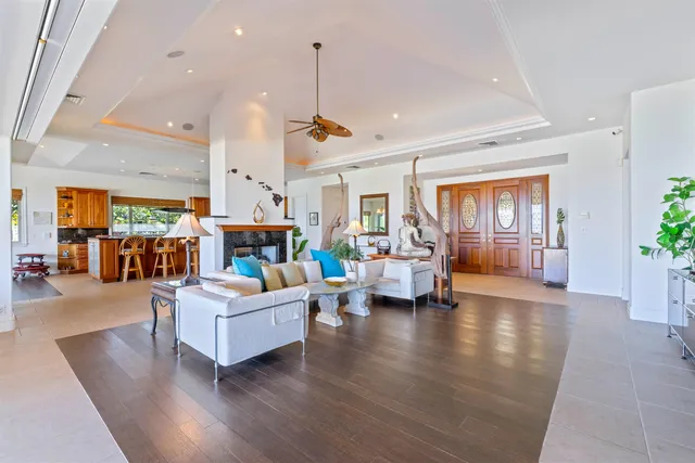 a living room with fireplace furniture and a wooden floor