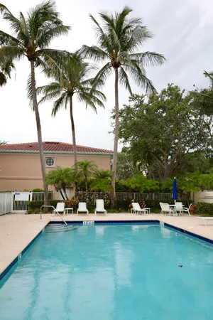 a row of palm trees and outdoor seating