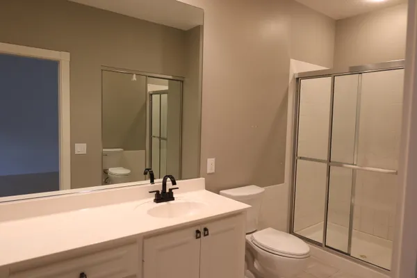 a bathroom with a sink a toilet and vanity