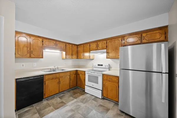 a kitchen with a sink stove and cabinets