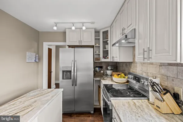 a kitchen with a sink stove top oven and cabinets