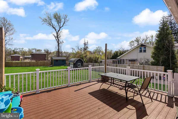 a view of a roof deck with chair and wooden floor