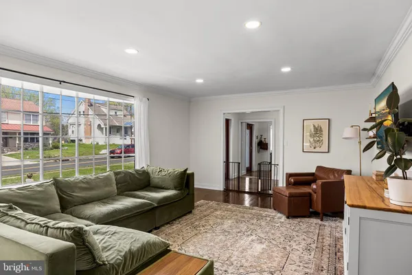 a living room with furniture and painting on the wall