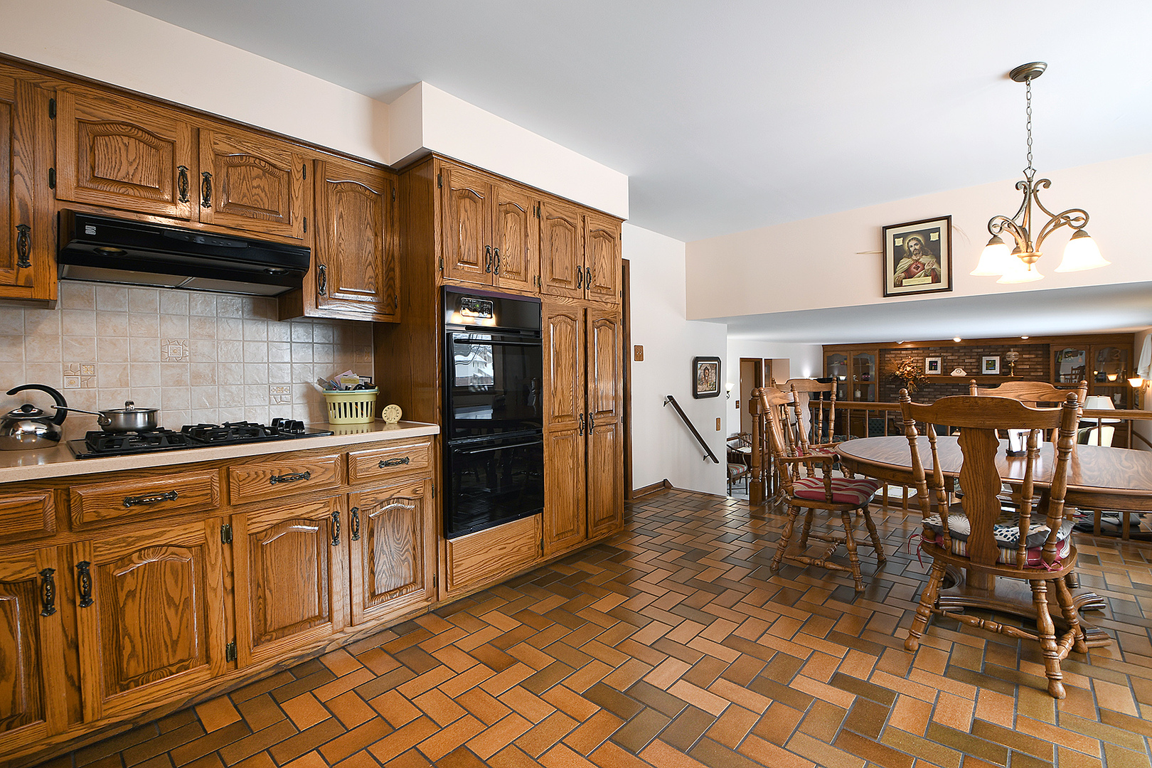 15 87th Street Burr Ridge, IL 60527 - Photo 11 of 34 a kitchen with stainless steel appliances granite countertop a refrigerator a stove a sink with dining table and chairs