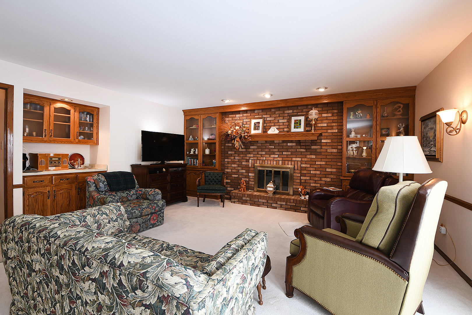 15 87th Street Burr Ridge, IL 60527 - Photo 15 of 34 a living room with furniture a fireplace and a flat screen tv