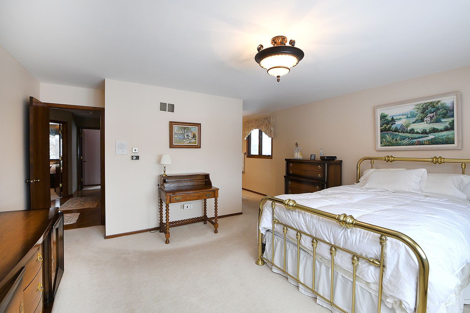 15 87th Street Burr Ridge, IL 60527 - Photo 21 of 34 a bedroom with a bed and a chandelier