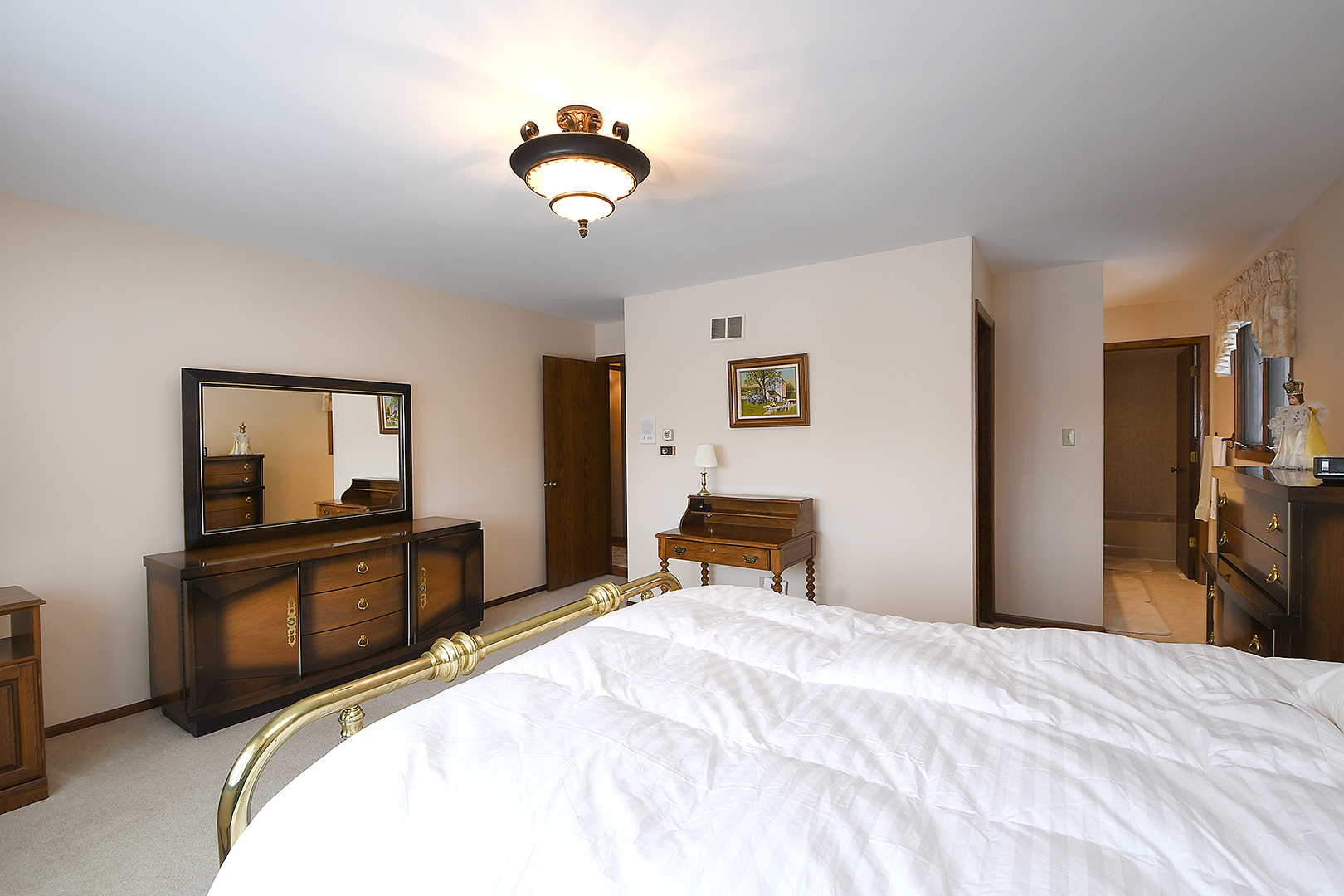 15 87th Street Burr Ridge, IL 60527 - Photo 22 of 34 a bedroom with a bed and a chandelier