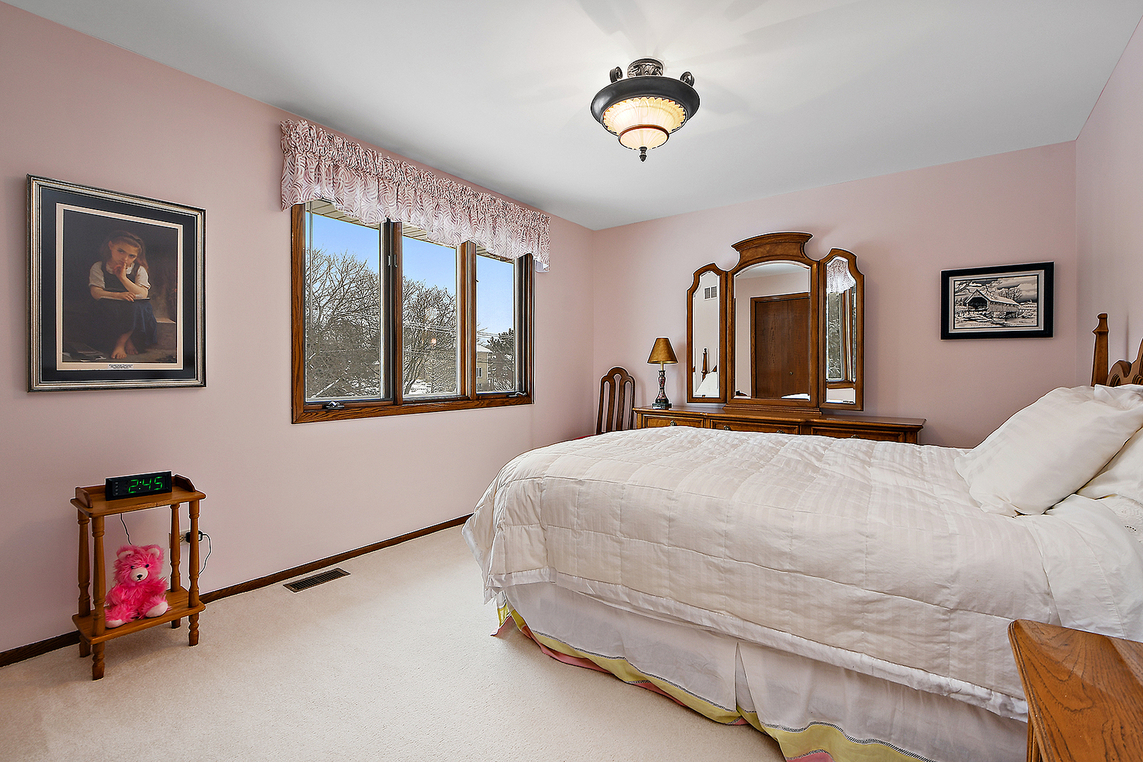 15 87th Street Burr Ridge, IL 60527 - Photo 28 of 34 a bedroom with a bed and a chandelier