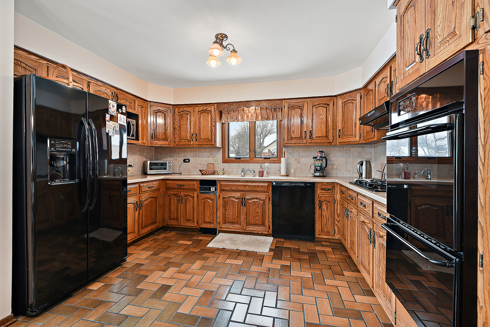 15 87th Street Burr Ridge, IL 60527 - Photo 10 of 34 a kitchen with stainless steel appliances granite countertop a refrigerator stove top oven a sink and dishwasher