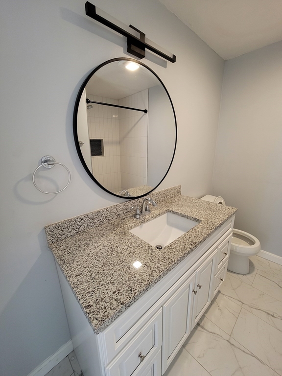 7 Gibbs Street, Unit 7 Worcester, MA 01607 - Photo 15 of 20 wooden floor with a sink and a mirror