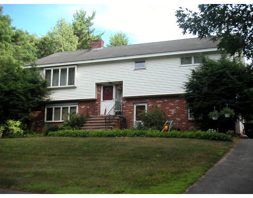 516 Lowell Road Groton, MA 01450 - Photo 1 of 1 a front view of house with a garden