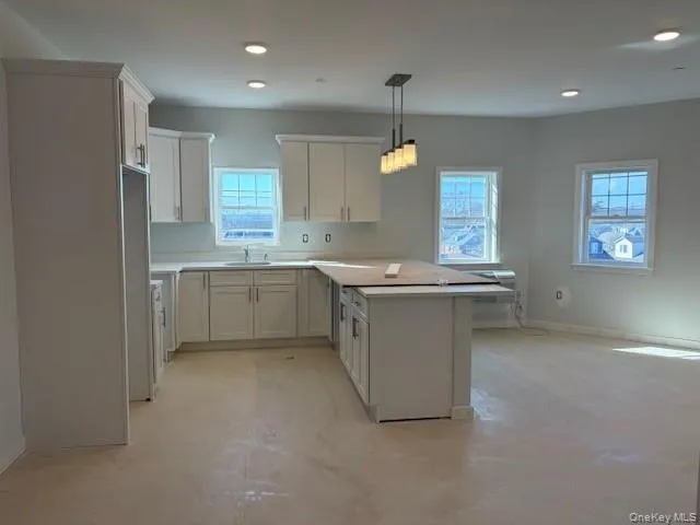 a kitchen with a sink stove and cabinets