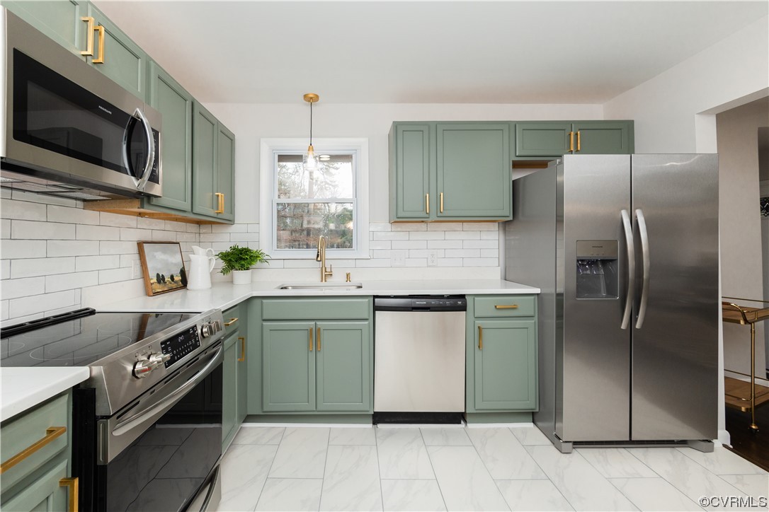 7714 Cherokee Road Richmond, VA 23225 - Photo 12 of 48 a kitchen with stainless steel appliances granite countertop a sink a stove a refrigerator and a microwave