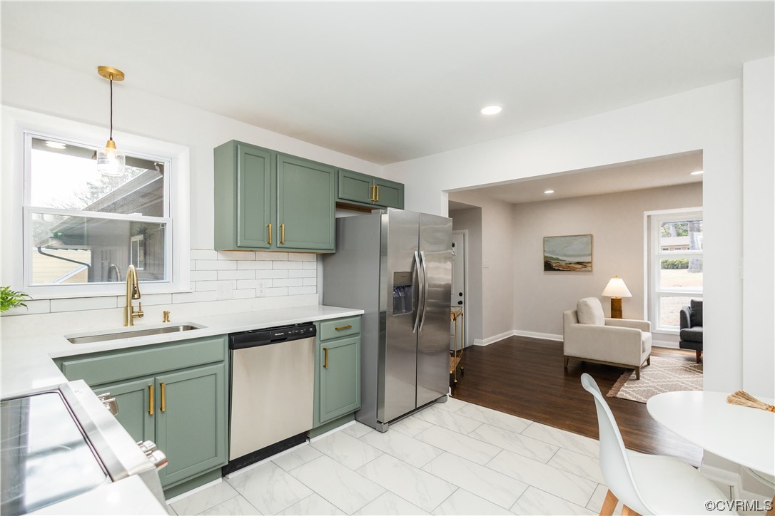 7714 Cherokee Road Richmond, VA 23225 - Photo 14 of 48 a kitchen with stainless steel appliances kitchen island granite countertop a sink and cabinets
