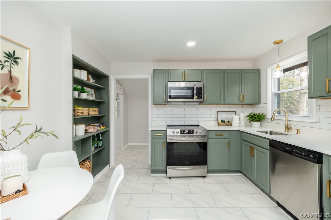 7714 Cherokee Road Richmond, VA 23225 - Photo 15 of 48 a kitchen with stainless steel appliances granite countertop a sink dishwasher stove top oven and cabinets