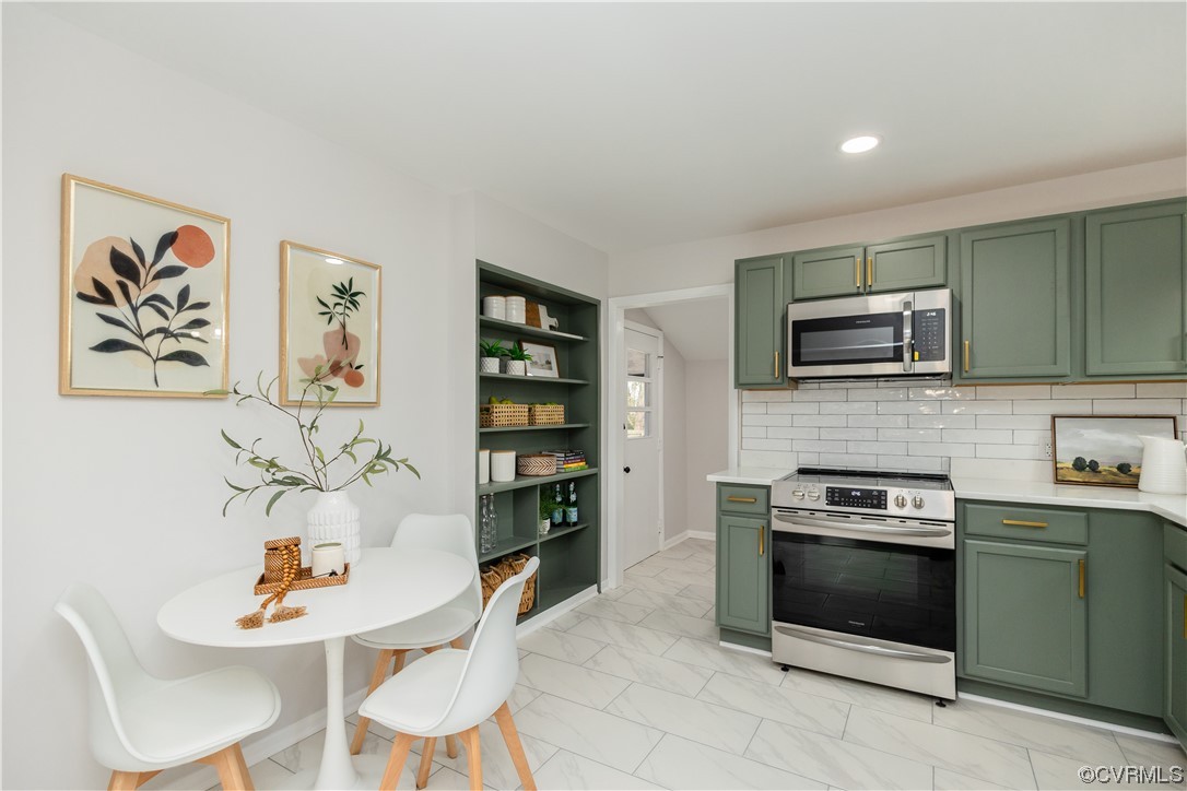 7714 Cherokee Road Richmond, VA 23225 - Photo 16 of 48 a kitchen with stainless steel appliances a stove a microwave a sink and cabinets