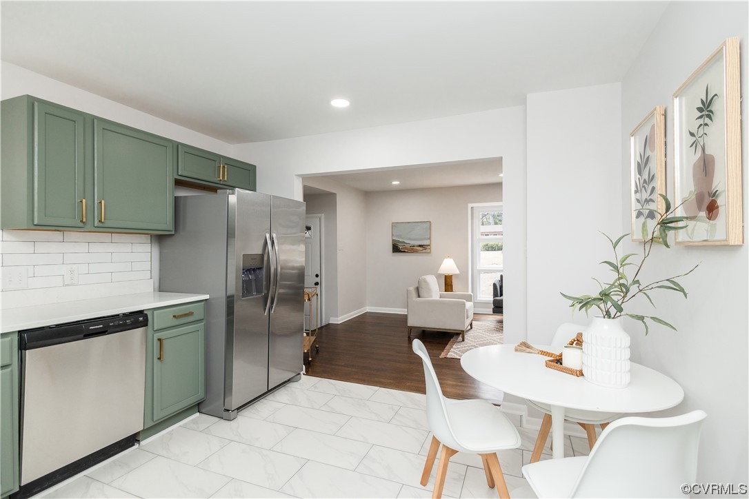 7714 Cherokee Road Richmond, VA 23225 - Photo 17 of 48 a kitchen with stainless steel appliances a refrigerator and a table