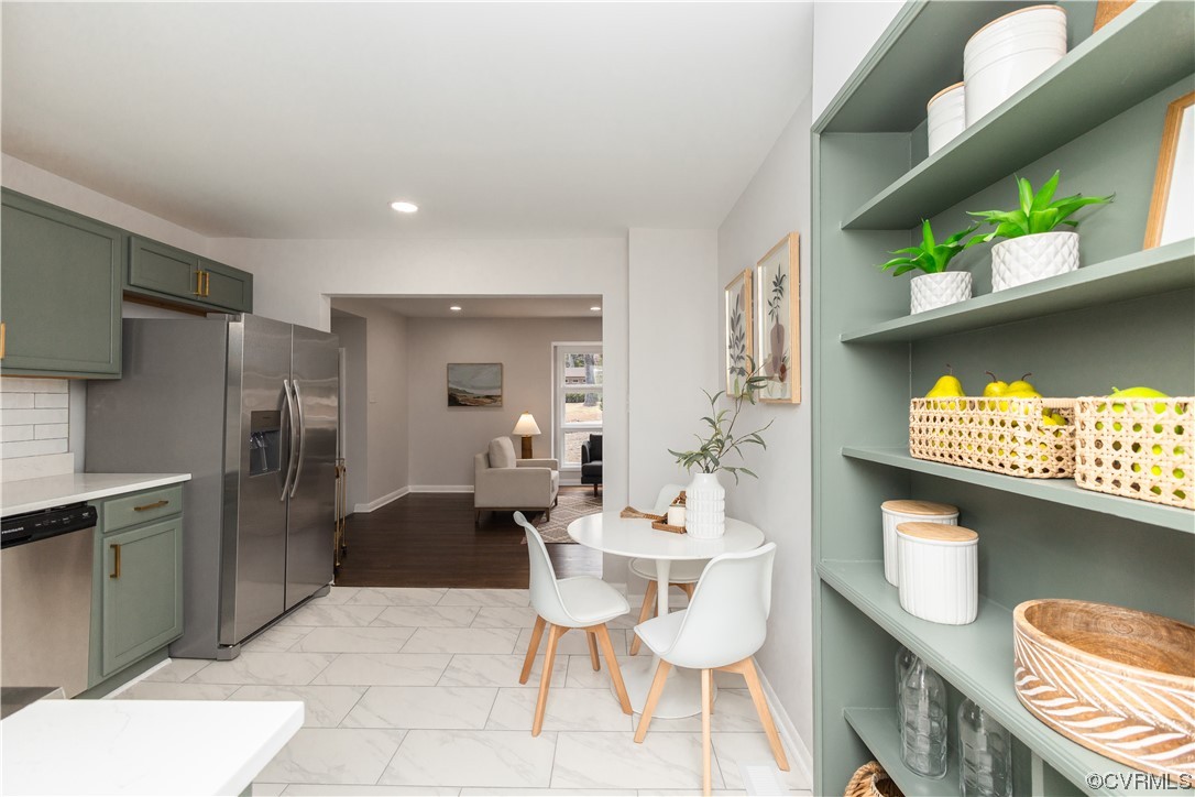 7714 Cherokee Road Richmond, VA 23225 - Photo 20 of 48 a living room with furniture a rug and a fireplace