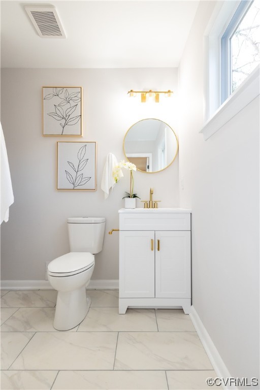 7714 Cherokee Road Richmond, VA 23225 - Photo 29 of 48 a bathroom with a toilet sink vanity and mirror