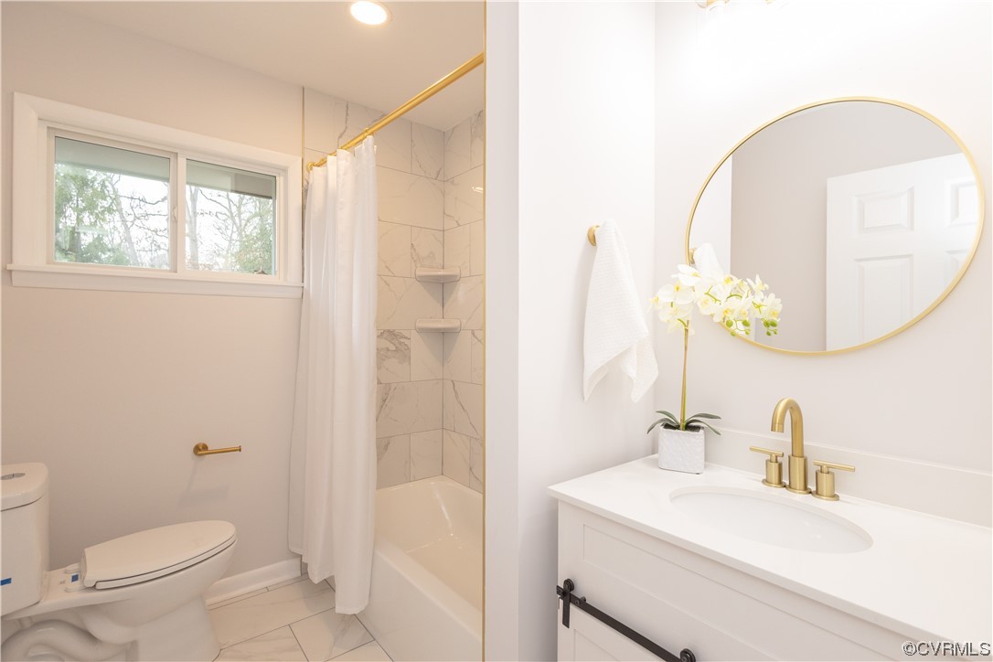 7714 Cherokee Road Richmond, VA 23225 - Photo 32 of 48 a bathroom with a sink a toilet and a mirror