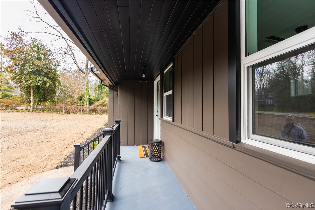 7714 Cherokee Road Richmond, VA 23225 - Photo 5 of 48 a view of a balcony with wooden floor and wooden fence