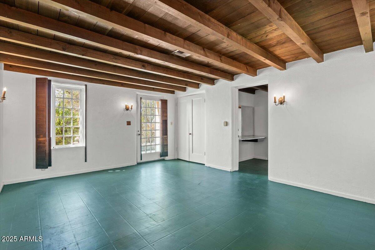 5702 East Camelback Road, Unit MEXICAN Phoenix, AZ 85251 - Photo 11 of 45 a view of an empty room with wooden floor and a window