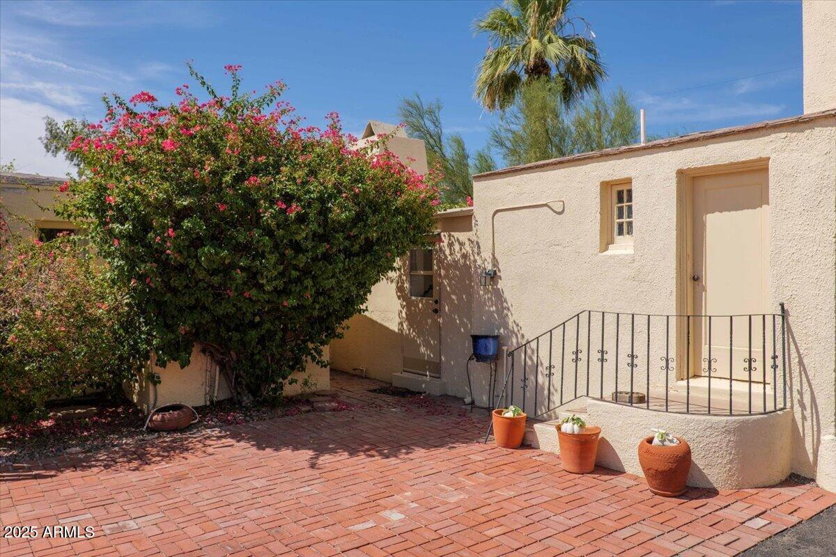 5702 East Camelback Road, Unit MEXICAN Phoenix, AZ 85251 - Photo 2 of 45 a balcony of a house with wooden floor and outdoor seating