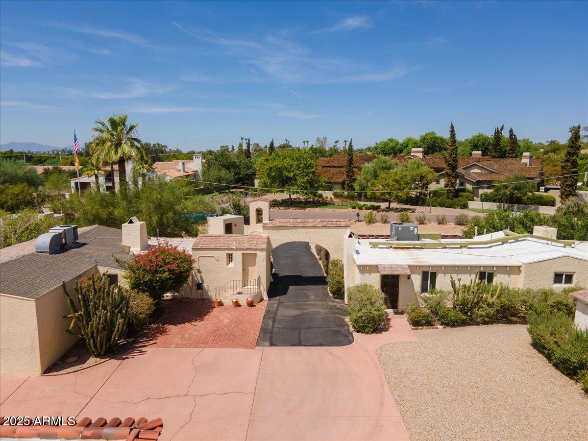 5702 East Camelback Road, Unit MEXICAN Phoenix, AZ 85251 - Photo 34 of 45 a view of a white house with a yard and potted plants