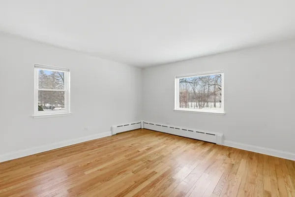 a view of a room with wooden floor and window