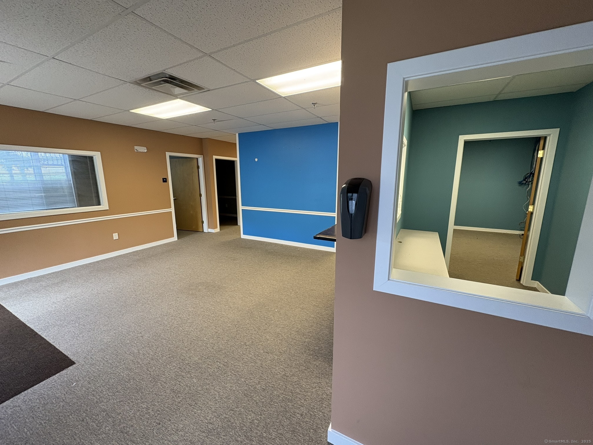 1575 Boston Post Road Guilford, CT 06437 - Photo 1 of 1 a view of an empty room with mirror on the wall