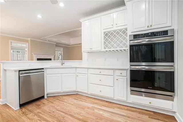 a kitchen with granite countertop cabinets stainless steel appliances and wooden floor
