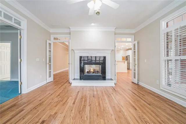 wooden floor fireplace and windows in an empty room