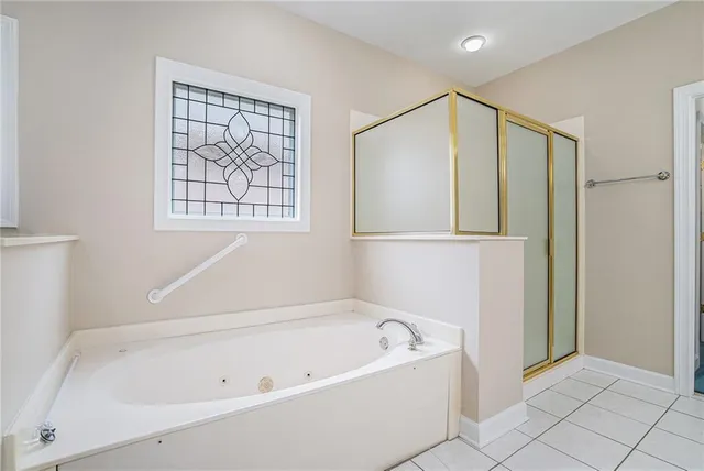 a bathroom with a bathtub and a shower
