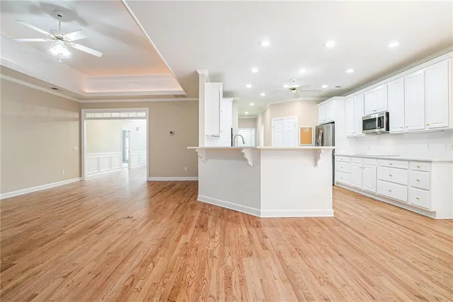 a view of kitchen with wooden floor and electronic appliances