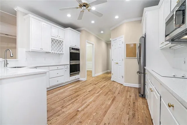 a kitchen with stainless steel appliances a refrigerator sink and cabinets