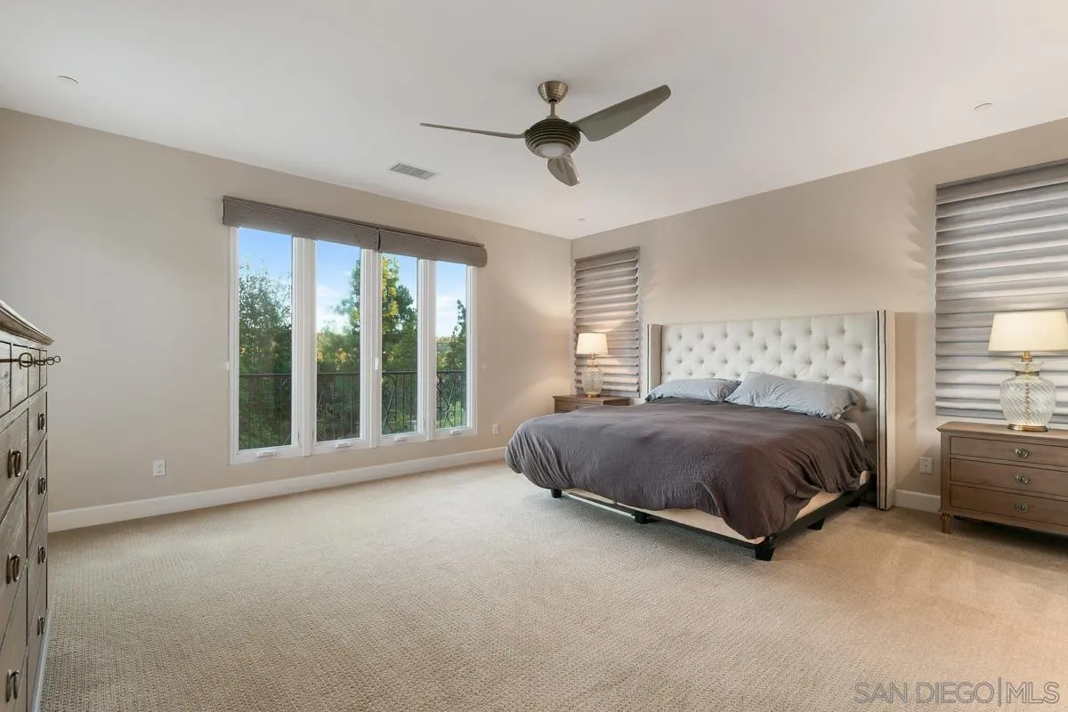 7923 Silvery Moon Lane Rancho Santa Fe, CA 92067 - Photo 14 of 22 a spacious bedroom with a bed and a large window