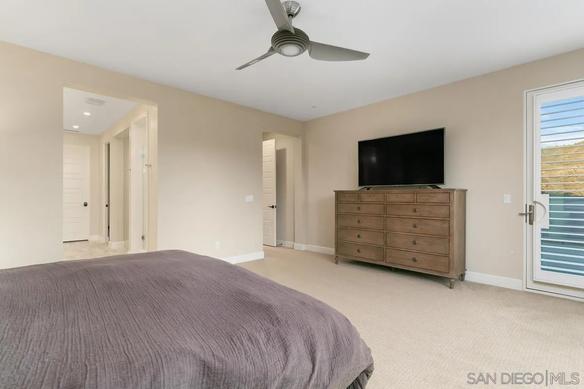7923 Silvery Moon Lane Rancho Santa Fe, CA 92067 - Photo 15 of 22 a bedroom with a bed and a flat screen tv in it