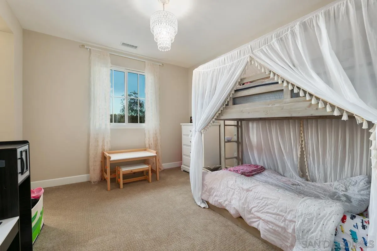 7923 Silvery Moon Lane Rancho Santa Fe, CA 92067 - Photo 17 of 22 a bed room with a bed and a chair