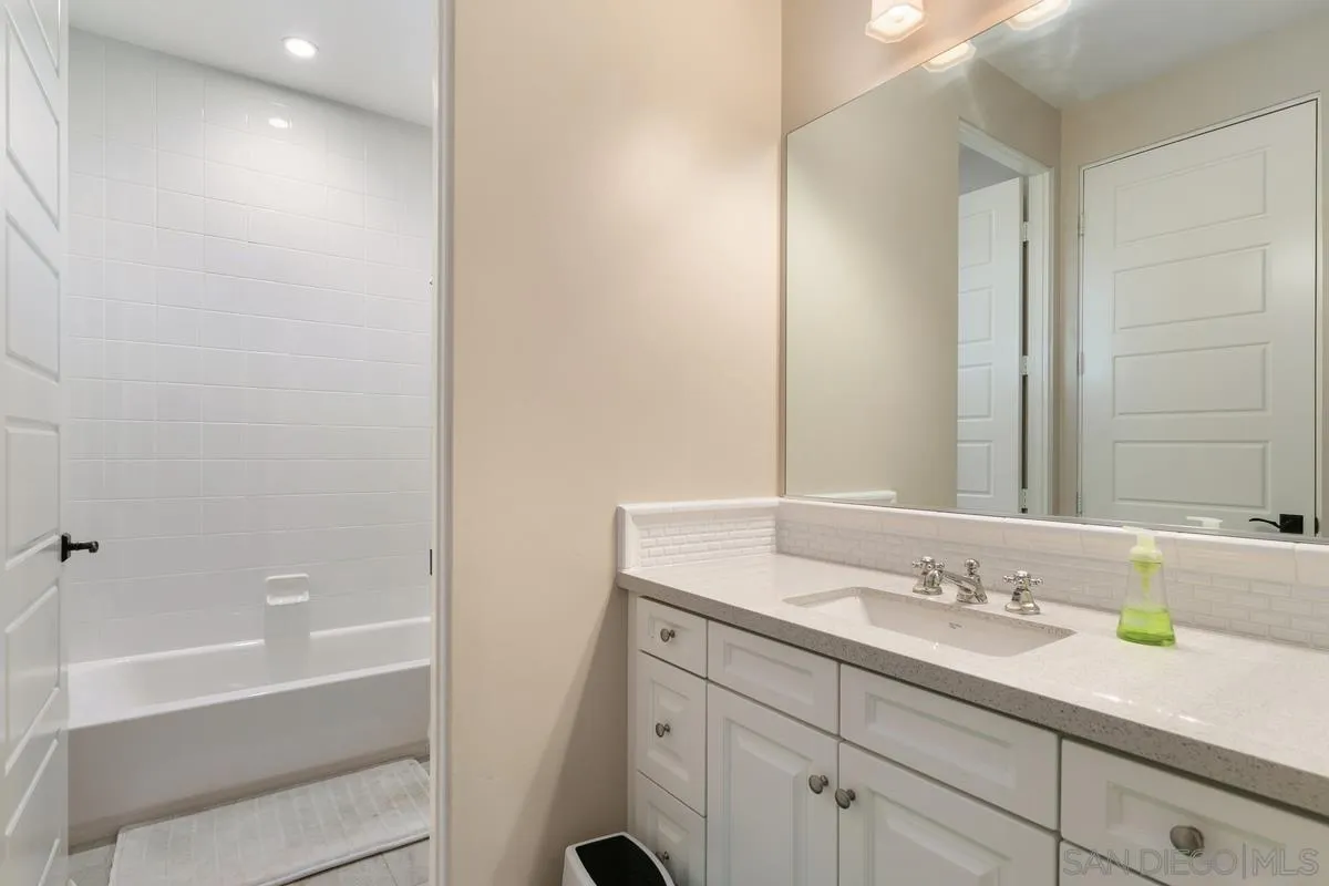 7923 Silvery Moon Lane Rancho Santa Fe, CA 92067 - Photo 18 of 22 a bathroom with a granite countertop sink and a bathtub