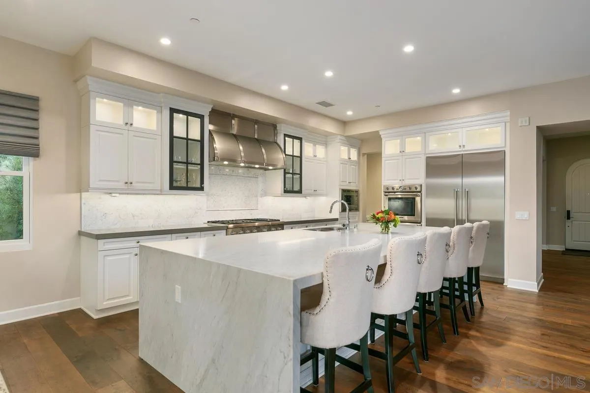 7923 Silvery Moon Lane Rancho Santa Fe, CA 92067 - Photo 2 of 22 a large kitchen with a table and chairs