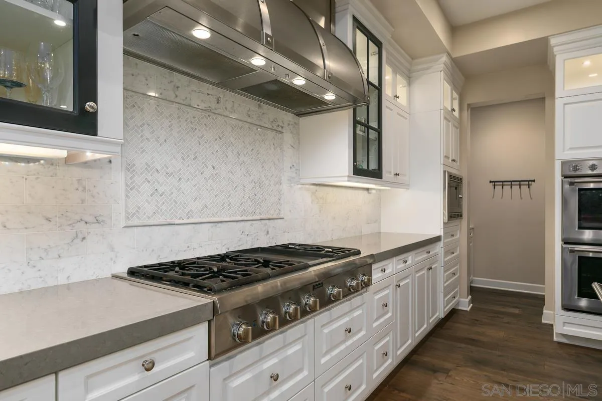 7923 Silvery Moon Lane Rancho Santa Fe, CA 92067 - Photo 3 of 22 a kitchen with granite countertop a stove and a sink