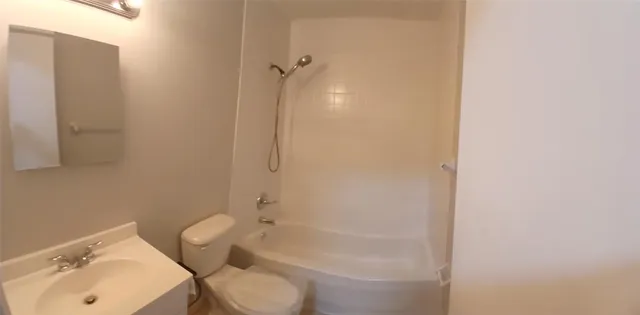 a bathroom with a toilet sink and shower