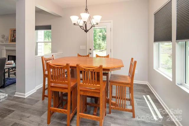 a view of a dining room with furniture wooden floor and chandelier