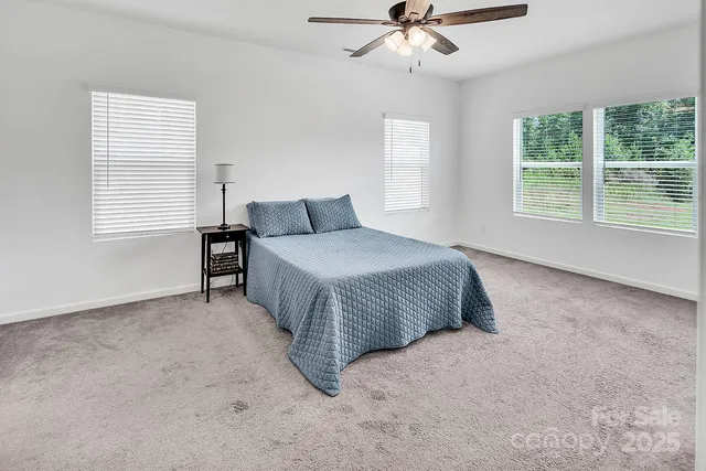 a spacious bedroom with a bed and window