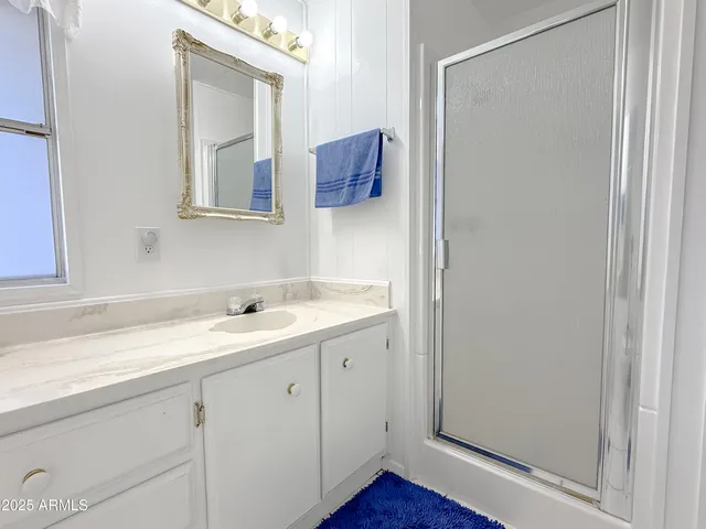 a bathroom with a sink vanity and mirror