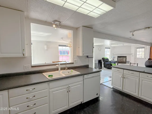 a kitchen with refrigerator stove and cabinets